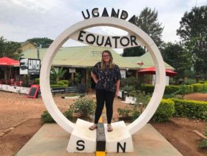 Sarah on the N-S Equator sign in Uganda