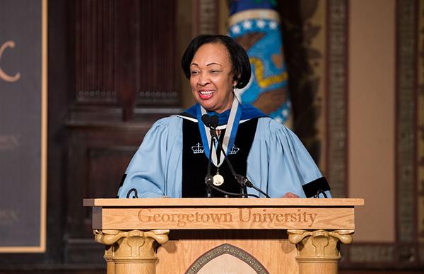 Professor Gwendolyn Mikell in regalia behind Georgetown University Podium at 2017 Faculty Convocation