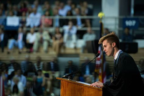 Photo of Alexander O'Neill (C'15) at podium in graduation gown